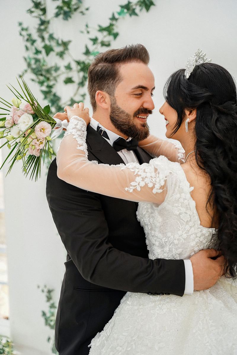 Bride and groom laughing together, close portrait